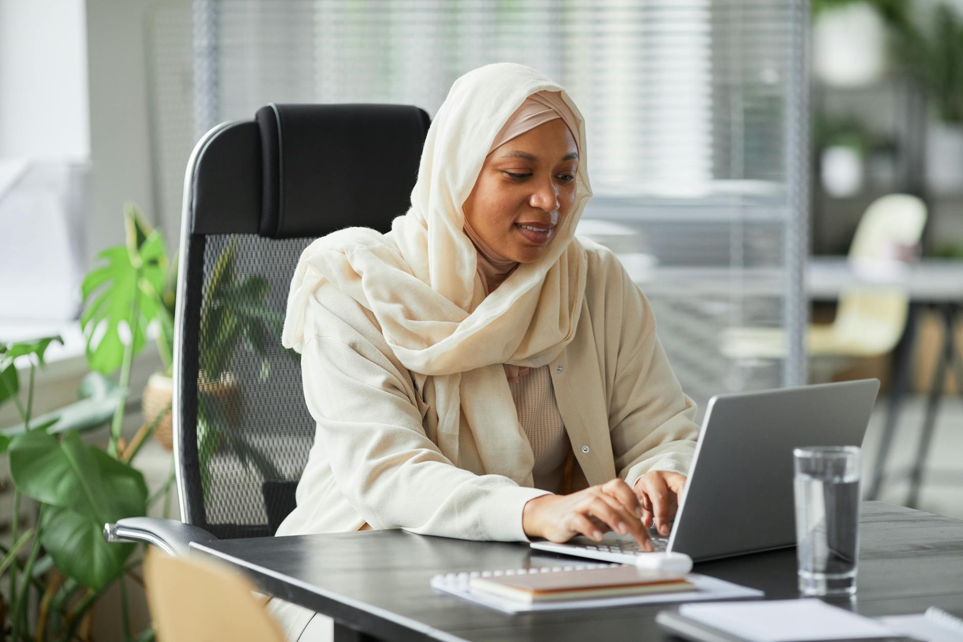 a woman in white hijab sitting at the table
